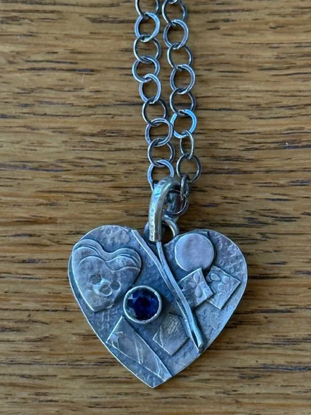 Fused silver heart with 6mm garnet.