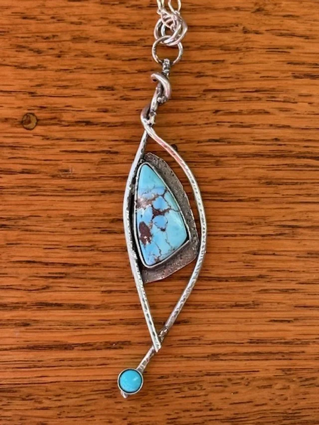 Two Turquoise stones set on silver.