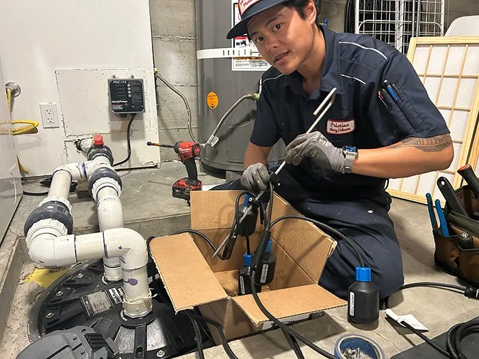 Plumber Working on Sewage Ejector