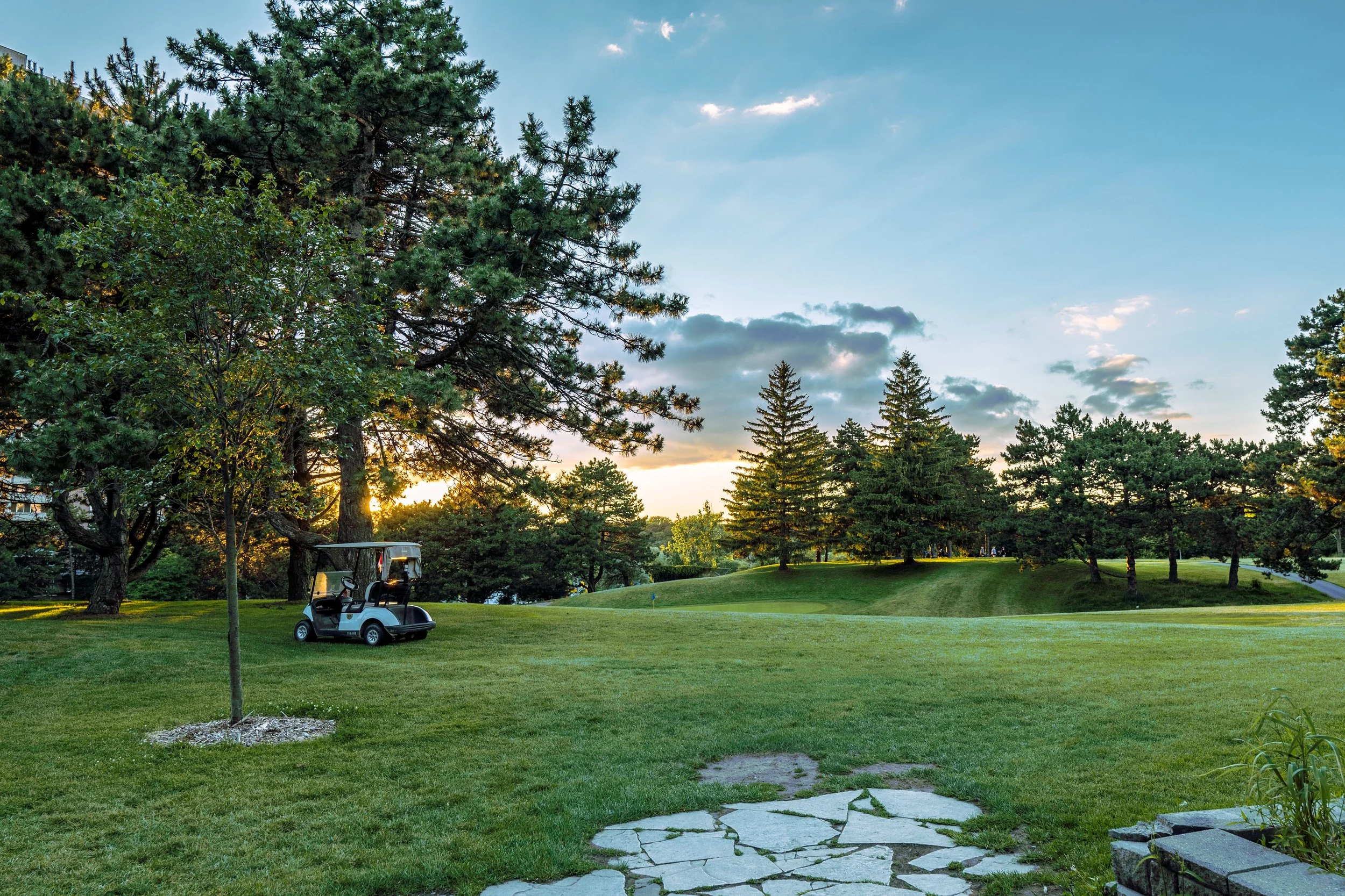 Golf cart parked near a fairway at sunset, one of many scenic golf courses in Missouri.