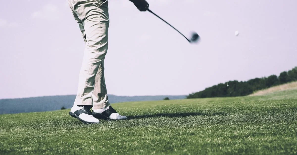 Golfer teeing off in a private golf community near Kansas City, Missouri.