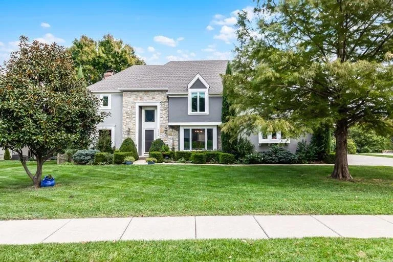 The front of a modern, luxury house for sale in Leawood, Kansas.