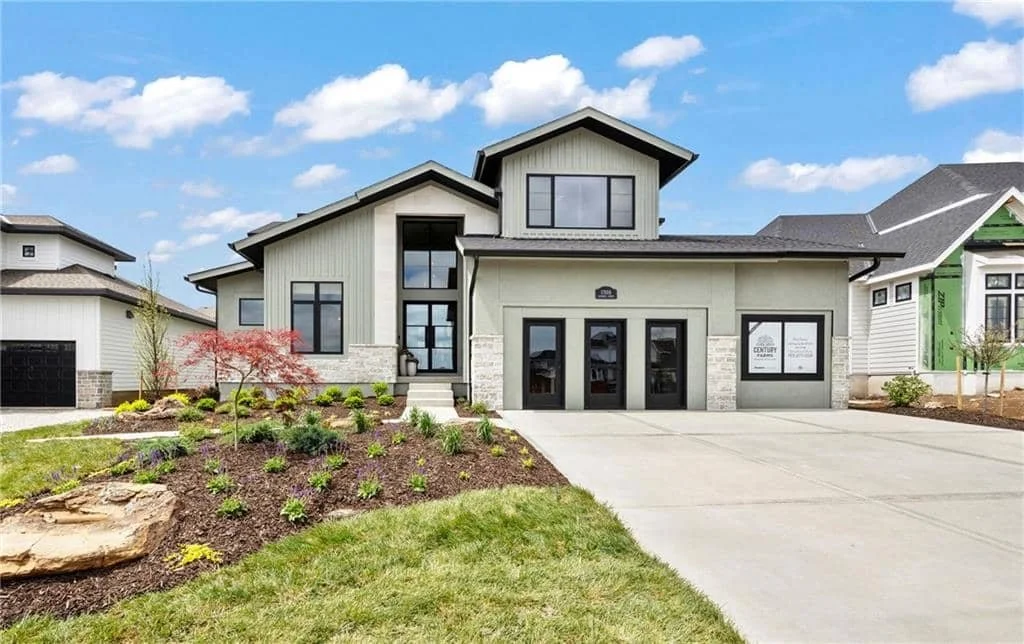 The front of a modern, luxury home for sale in the Overland Park community of Kansas City, Kansas.