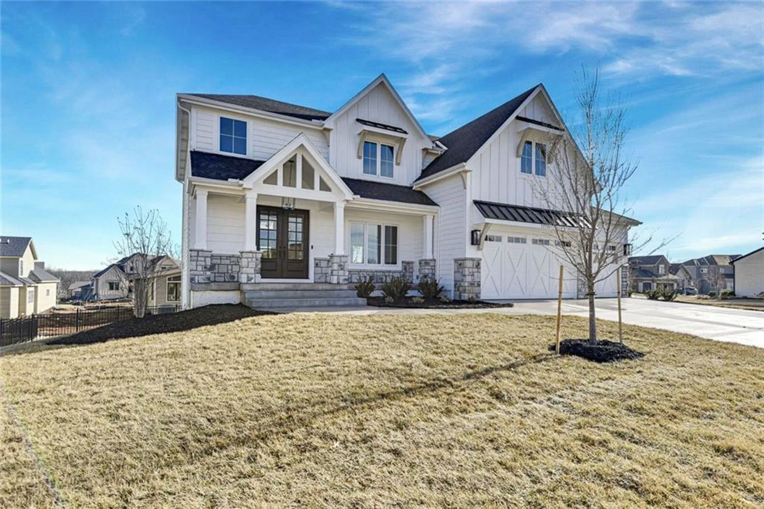 Building a new home in Overland Park Kansas with a classic blue and gray exterior design.
