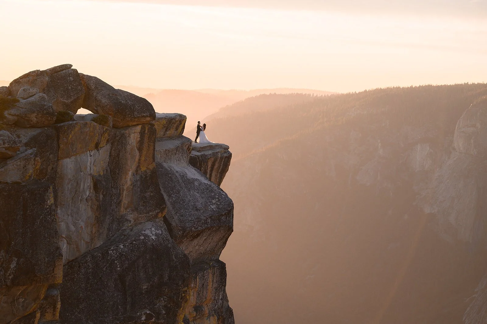 bride and groom at their wedding on a cliffside in Yosemite at Taft Point