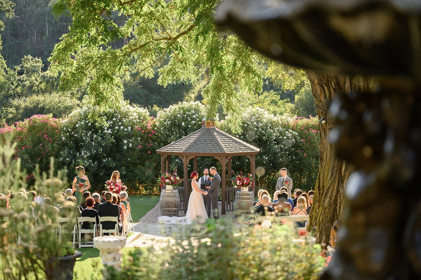 a bride and groom getting married under a gazebo at elliston vineyards