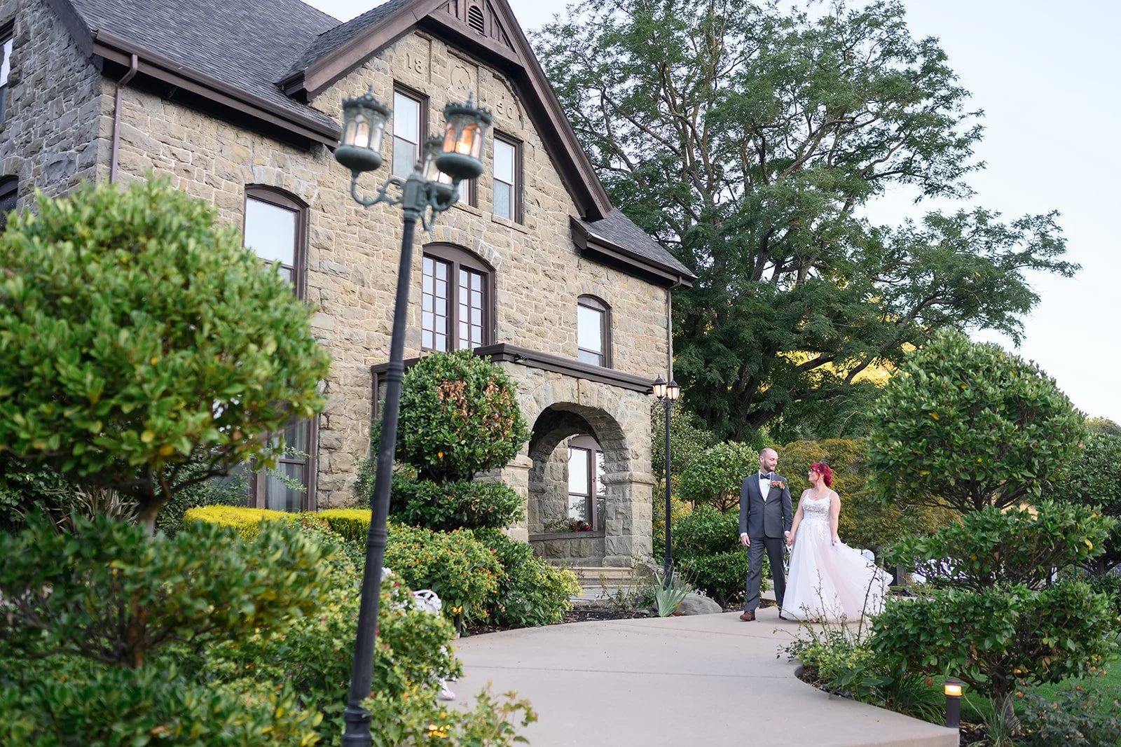 a bride and groom walking together at their wedding at elliston vineyards in sunol