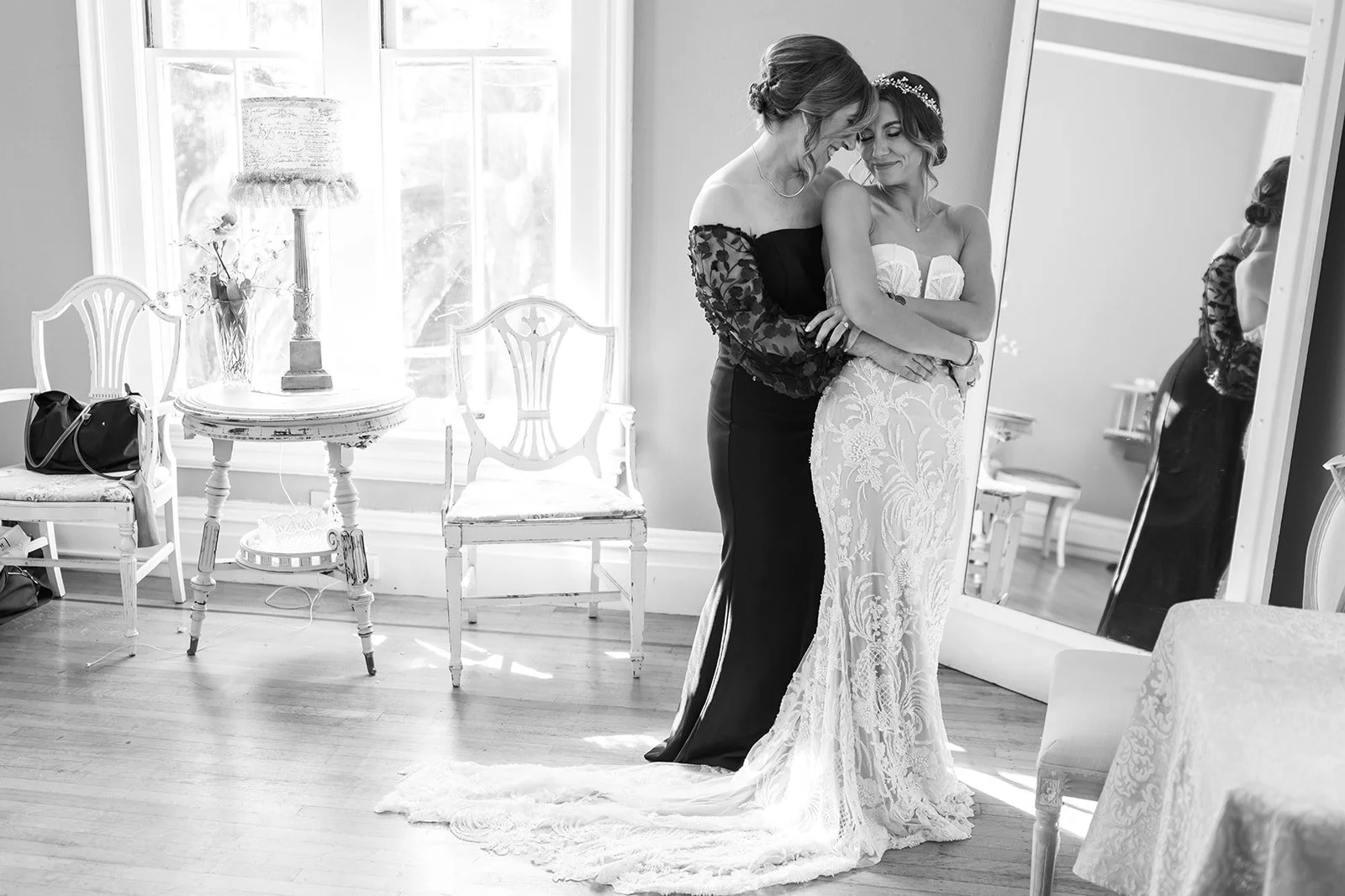 a first look of a bride with her mother at her wedding hugging