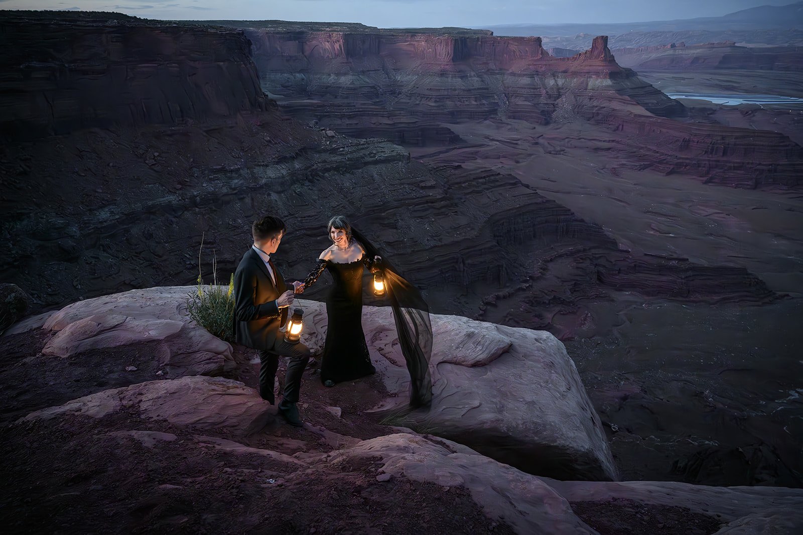 bride and groom in black attire with lanters in Moab at night on their adventure wedding