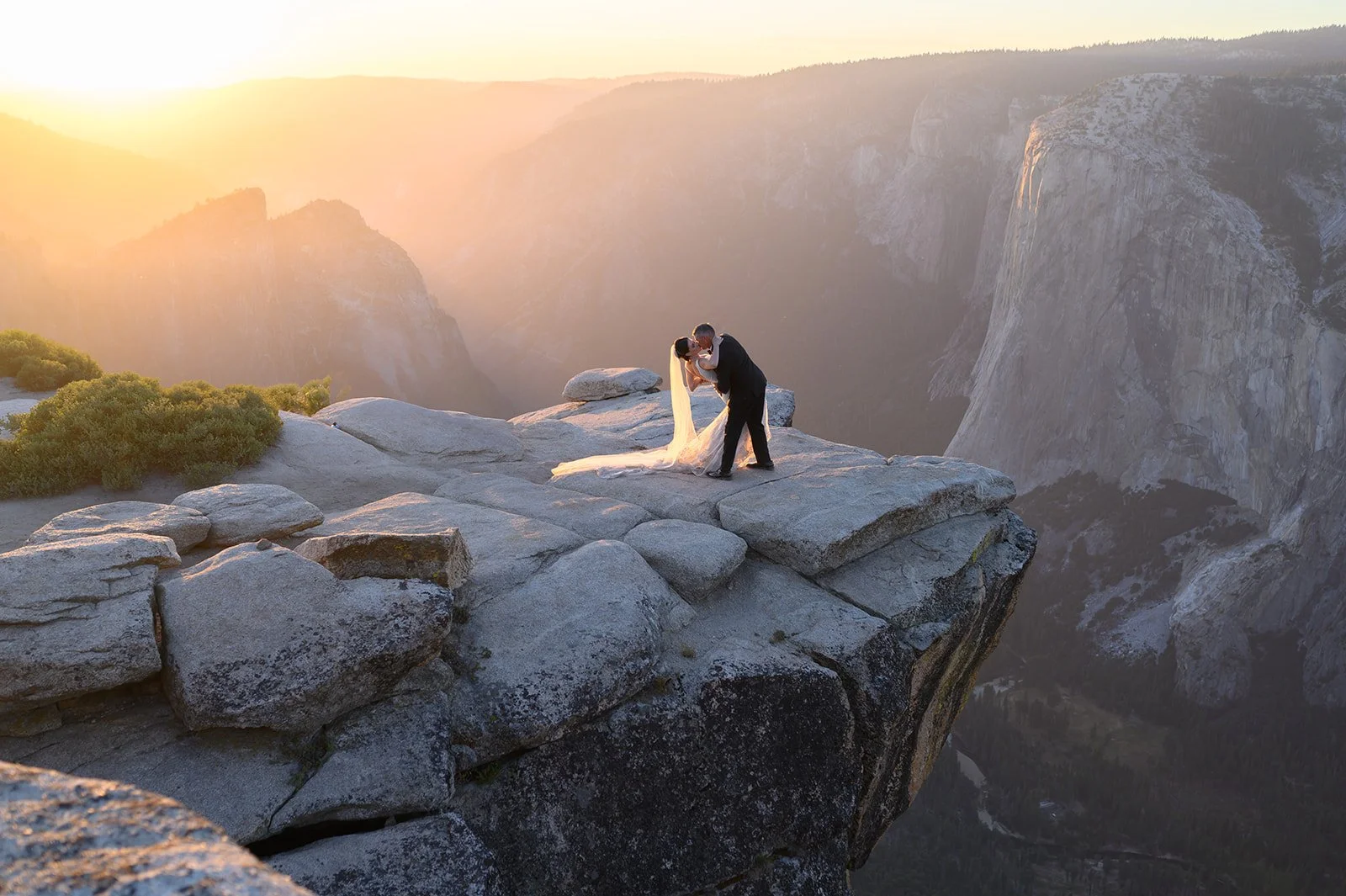an elopement with a bride and groom on a cliff in Yosemite on their wedding day