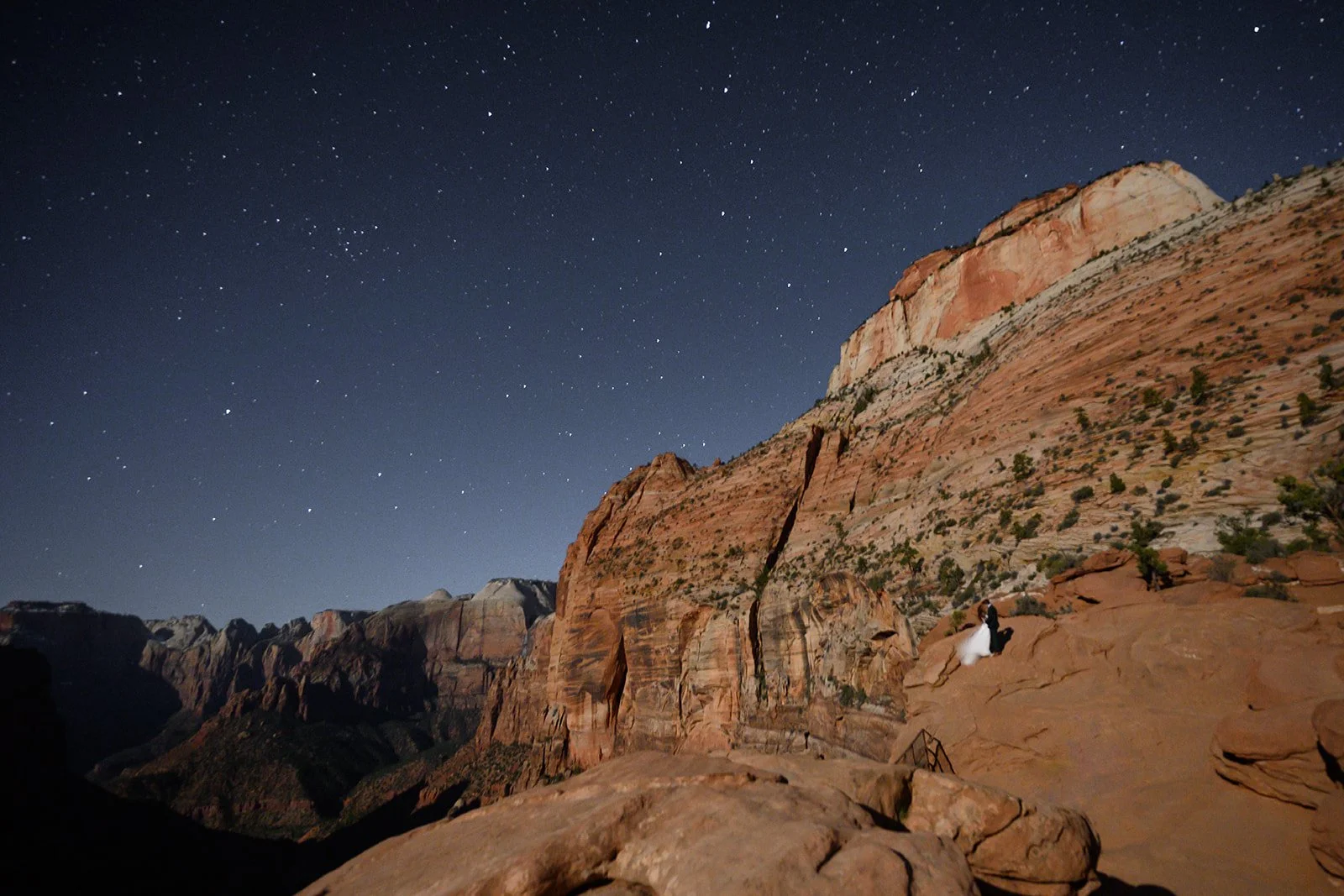 bride and groom in utah on their adventure elopement at night with lanterns