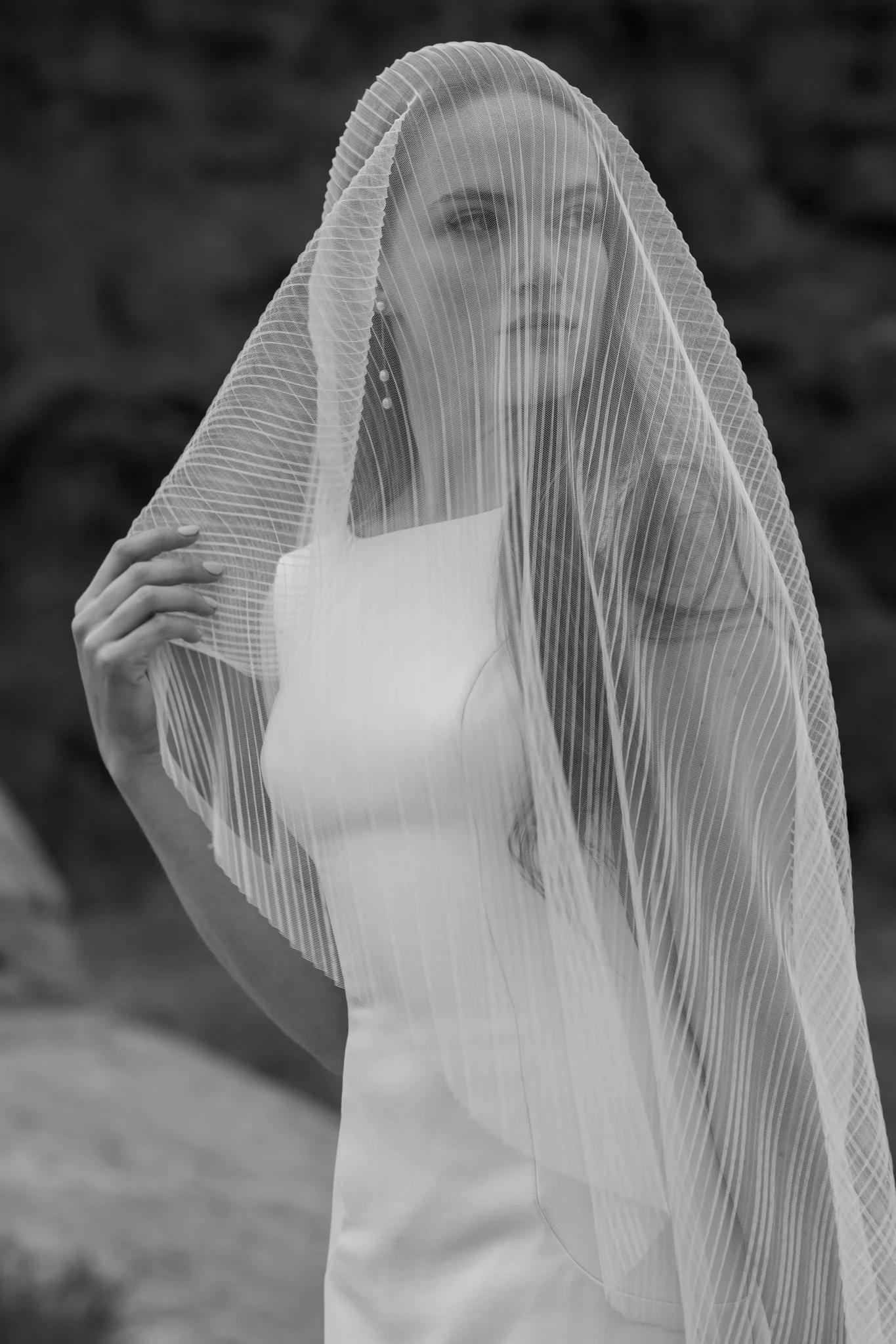 bride at her adventure elopement in Arches National Park in a black and white photo under a veil