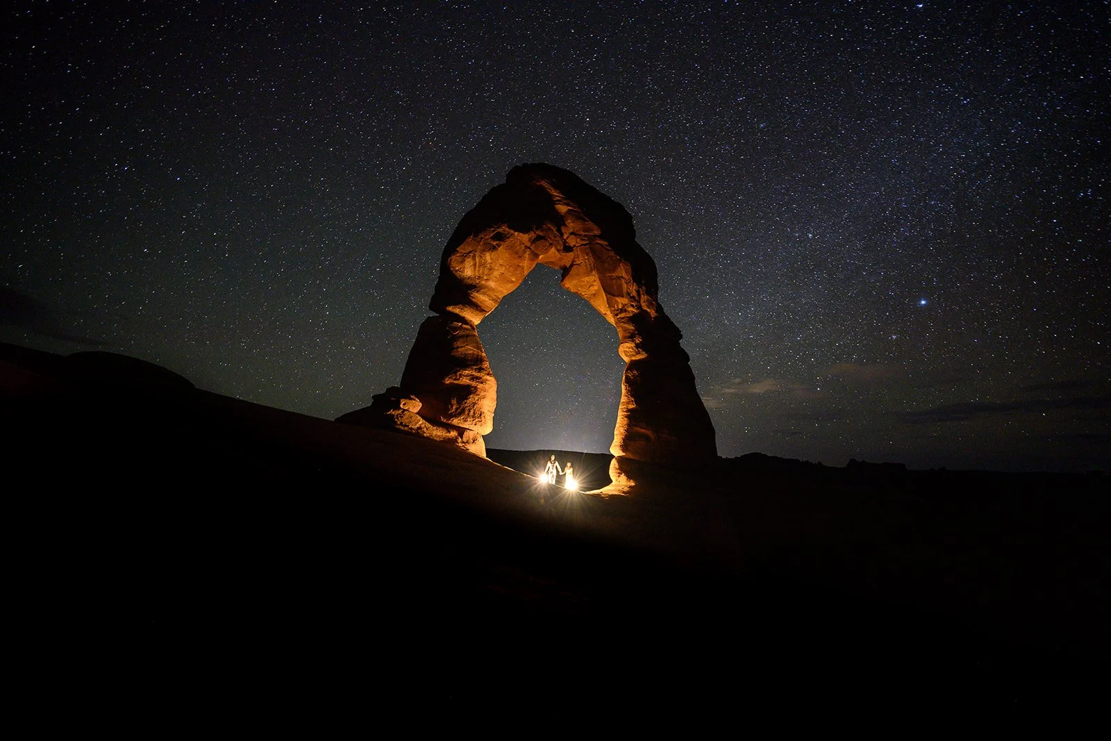 a photo of a bride and groom under the stars in Moab at their wedding