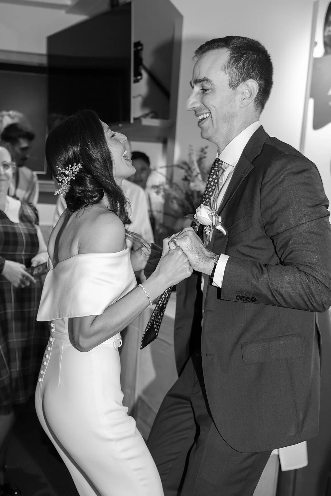 A photo of a bride and groom having their first dance at their reception in a restaurant