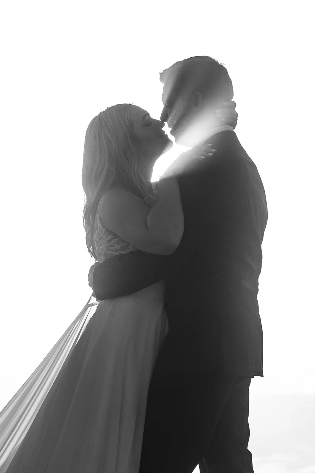 a black and white photo of a couple on their wedding day in big sur