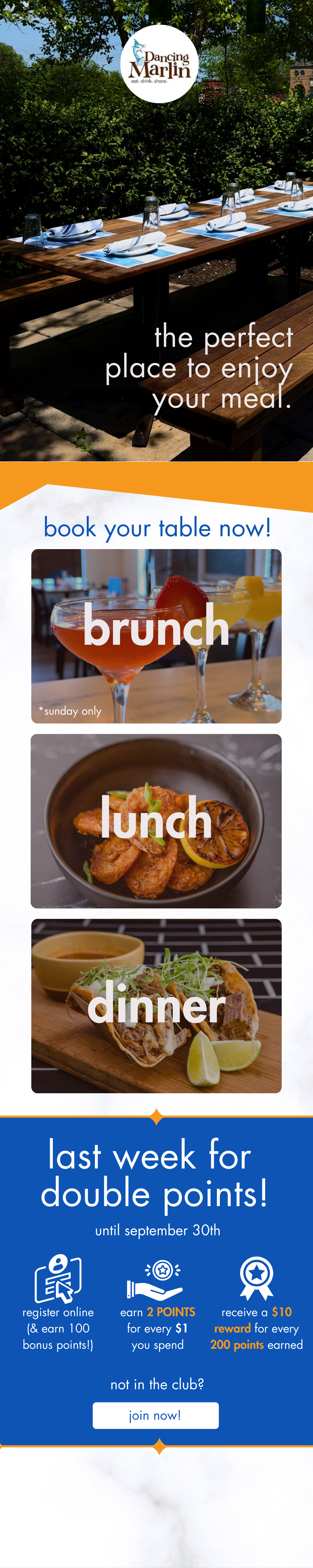 A restaurant outdoor dining area with a wooden table set for a meal, surrounded by greenery, and the restaurant's logo with the text 'Dancing Marlin Eat. Drink. Share.'