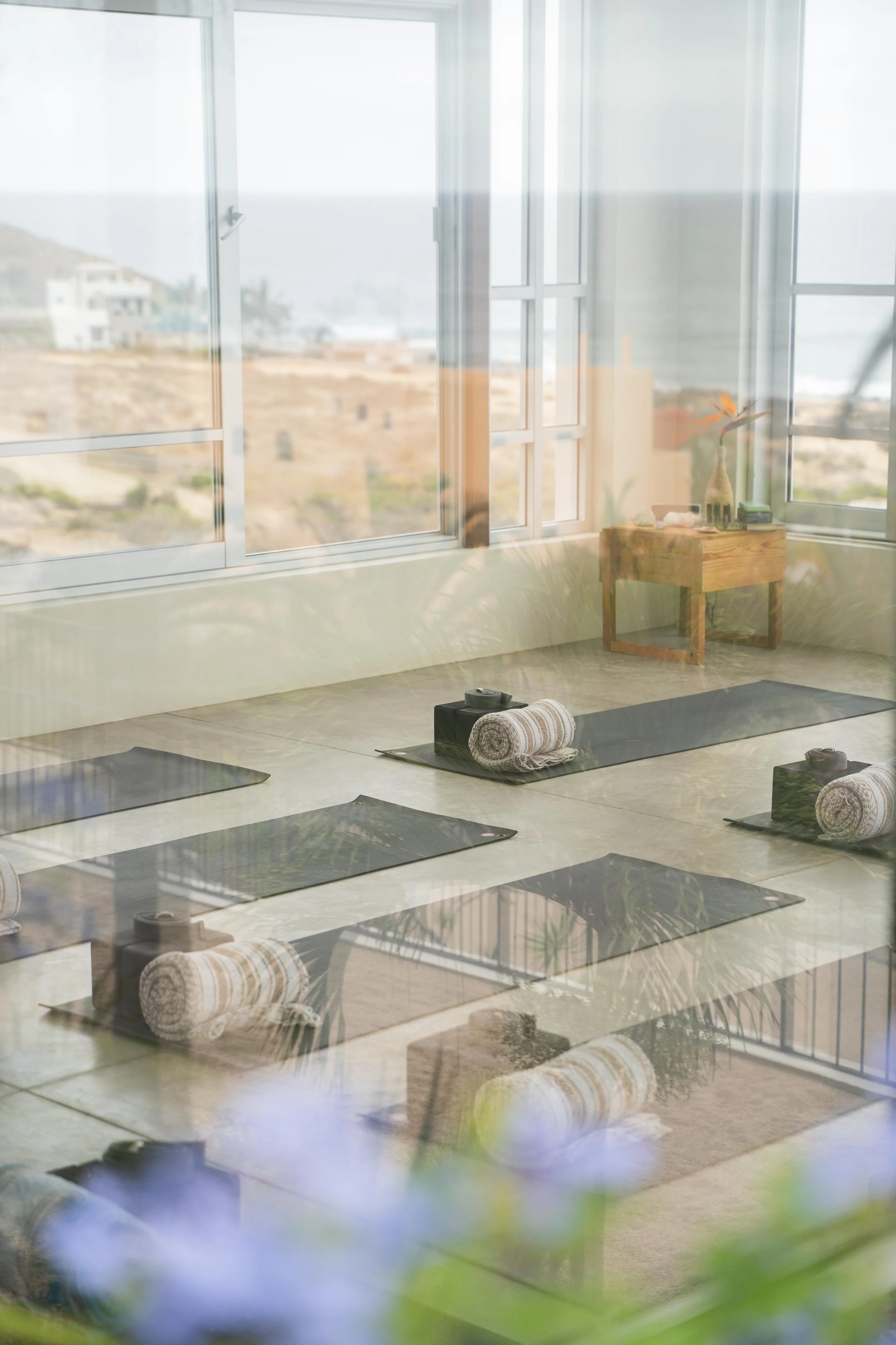 Manduka yoga mats and blocks are set up for a somatic men's wellness retreat in Baja California.