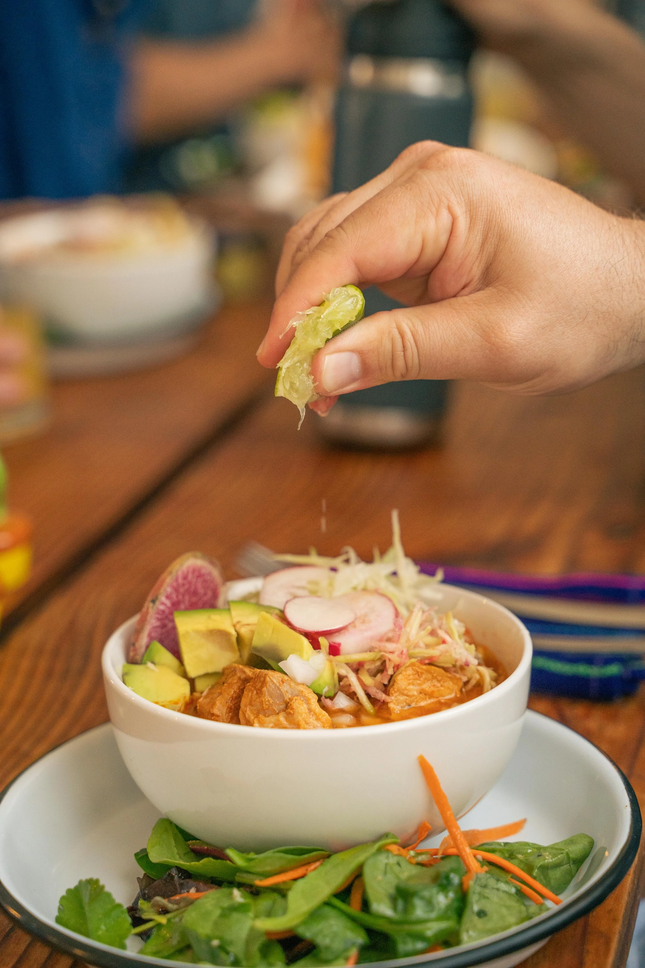 Close-up of fresh lime juice squeezed over a nourishing meal at SHIFT Men’s Retreat, a somatic retreat for men where healthy food supports emotional and physical healing.