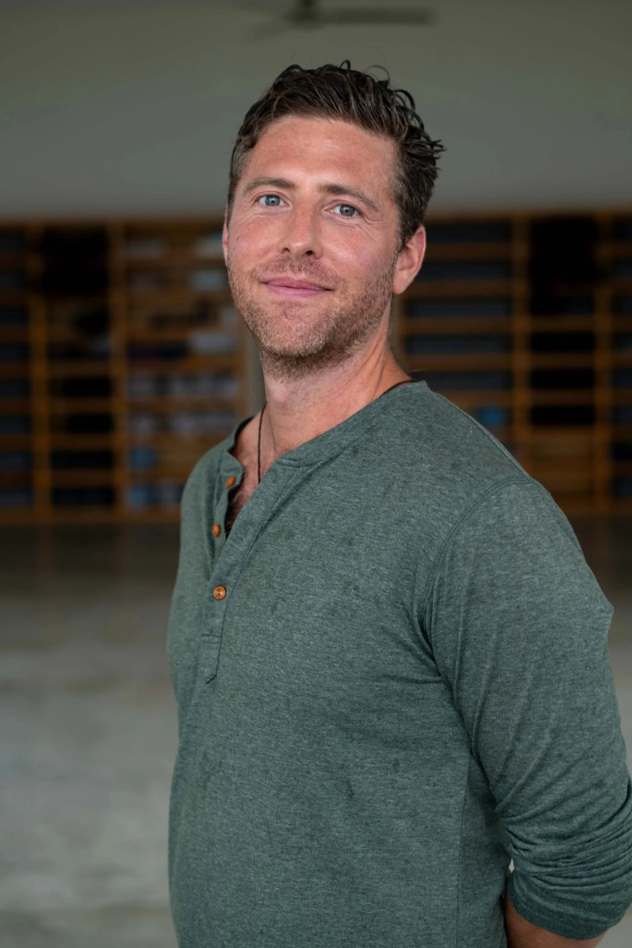 Holotropic breathwork facilitator, Brandt Miller, smiles at the camera at SHIFT Men's Retreat, a men's healing retreat in Baja California, Mexico.