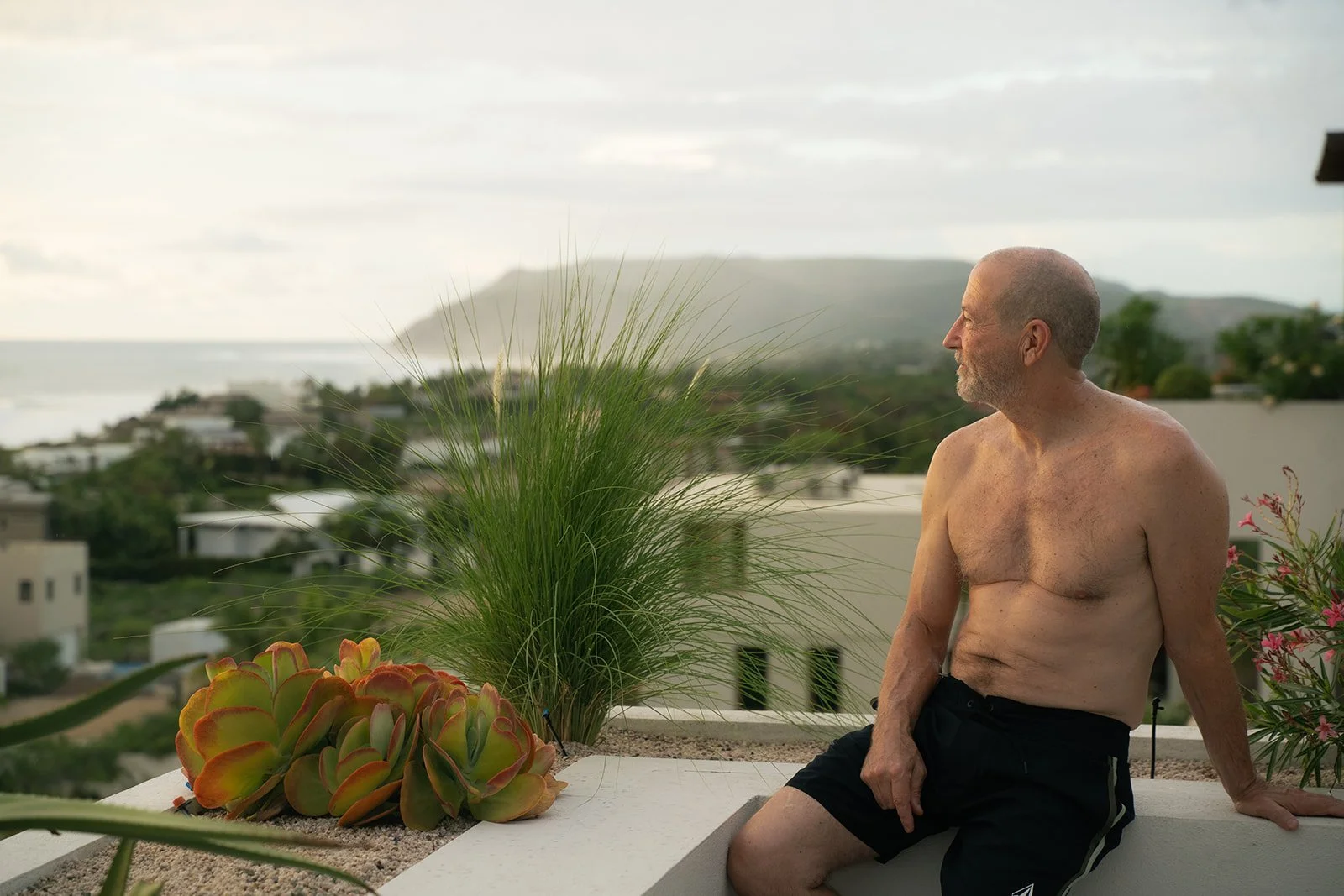An older, fit man contemplating the life underneath the goals at a somatic men's retreat.