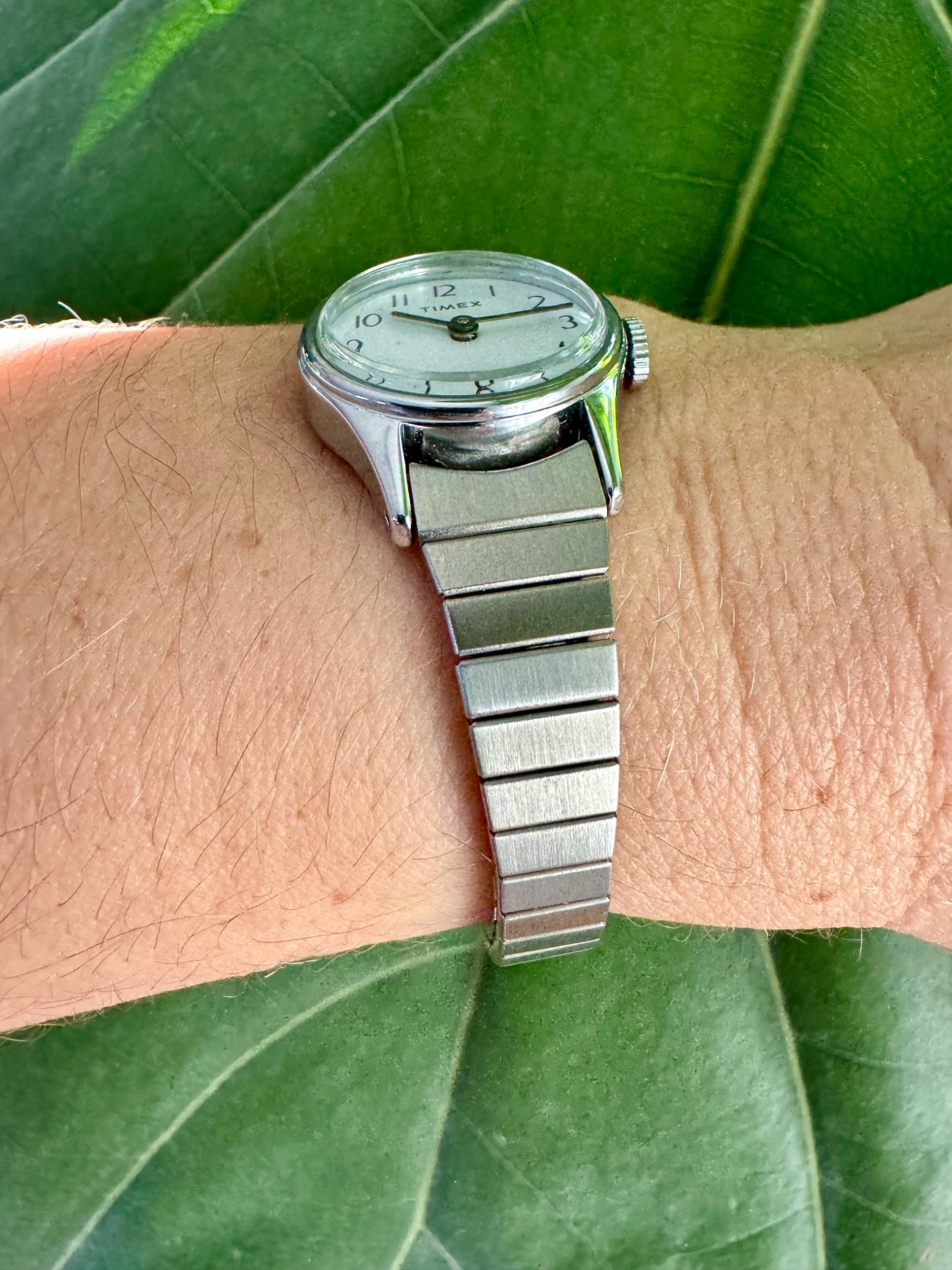 Side view of 1990s Timex mechanical watch in silver-tone, highlighting sleek, timeless design and durable craftsmanship