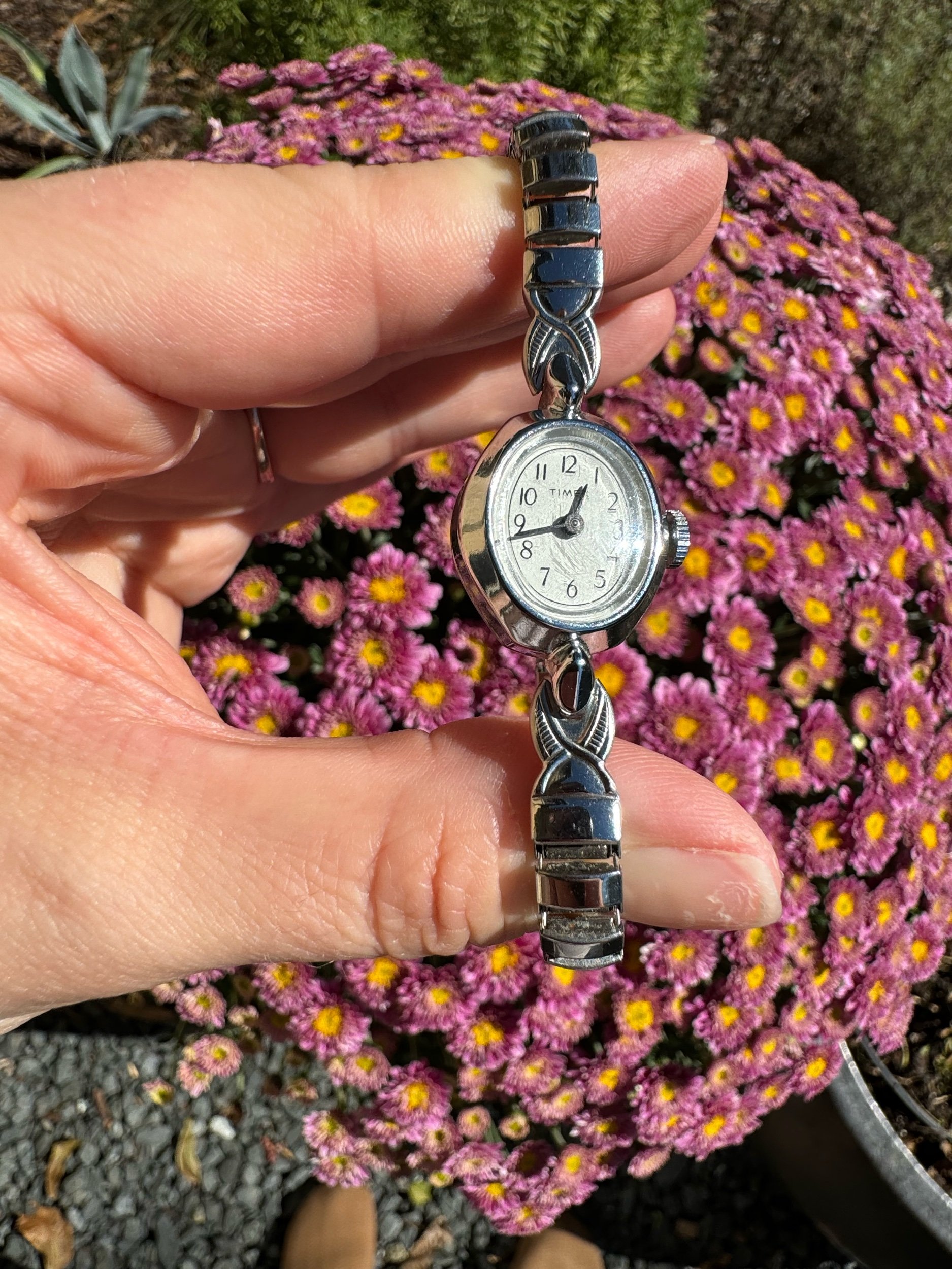 Vintage silver Timex watch on display, classic mechanical watch with 24-hour accuracy