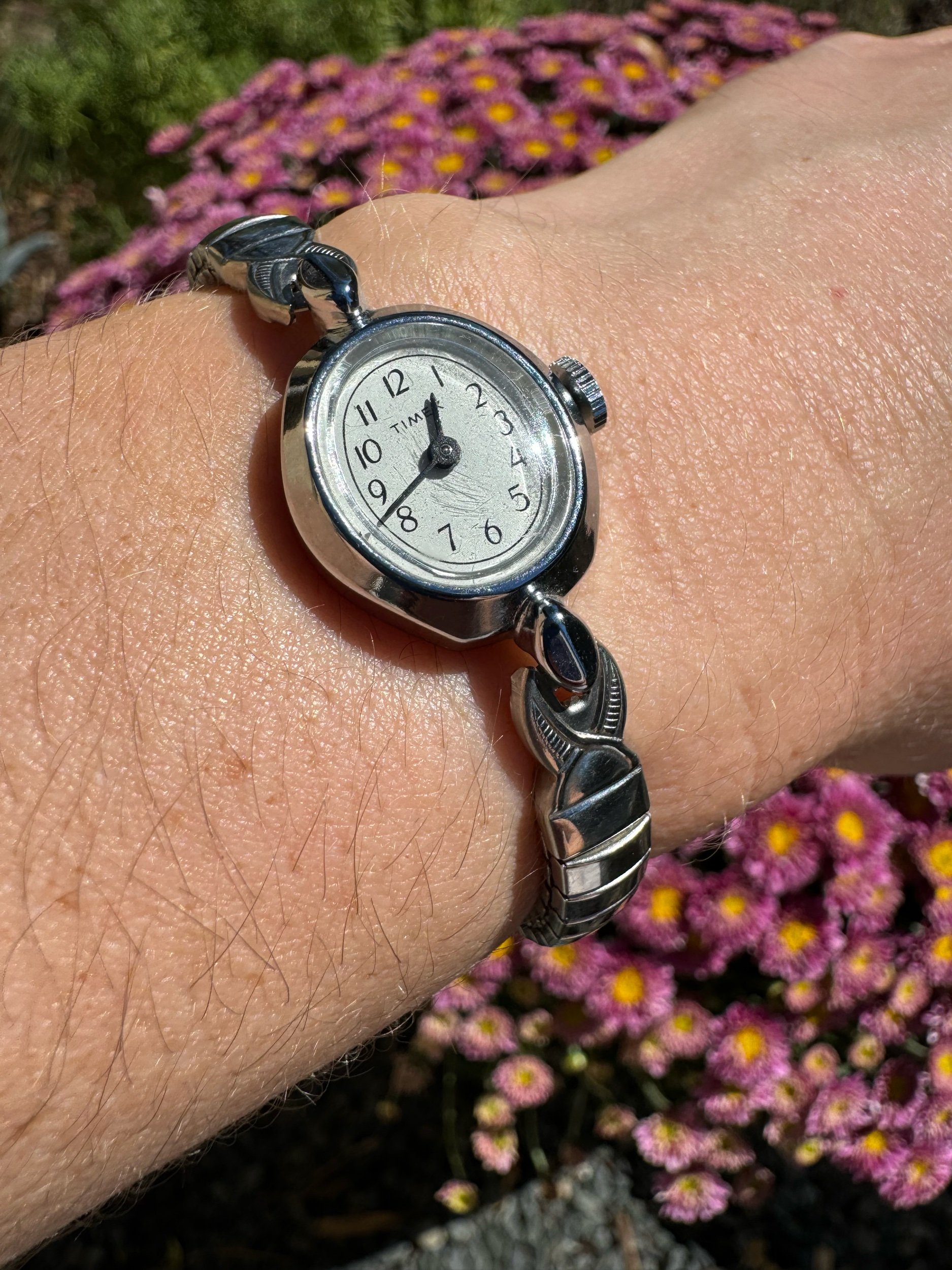 Vintage silver Timex mechanical watch with classic design, keeps time for 24 hours on a single wind.
