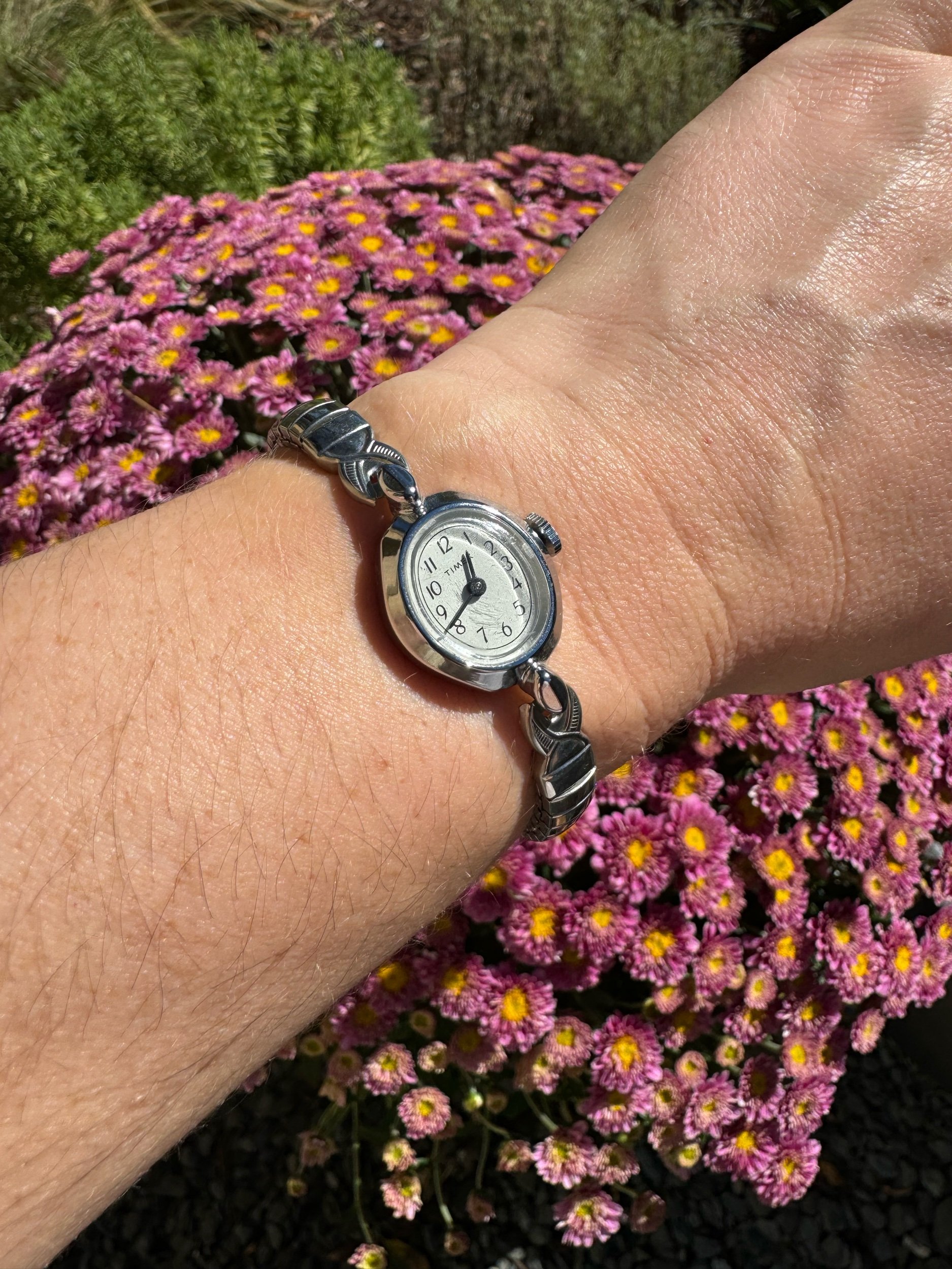 Vintage silver Timex mechanical watch with classic design, keeps time for 24 hours on a single wind.