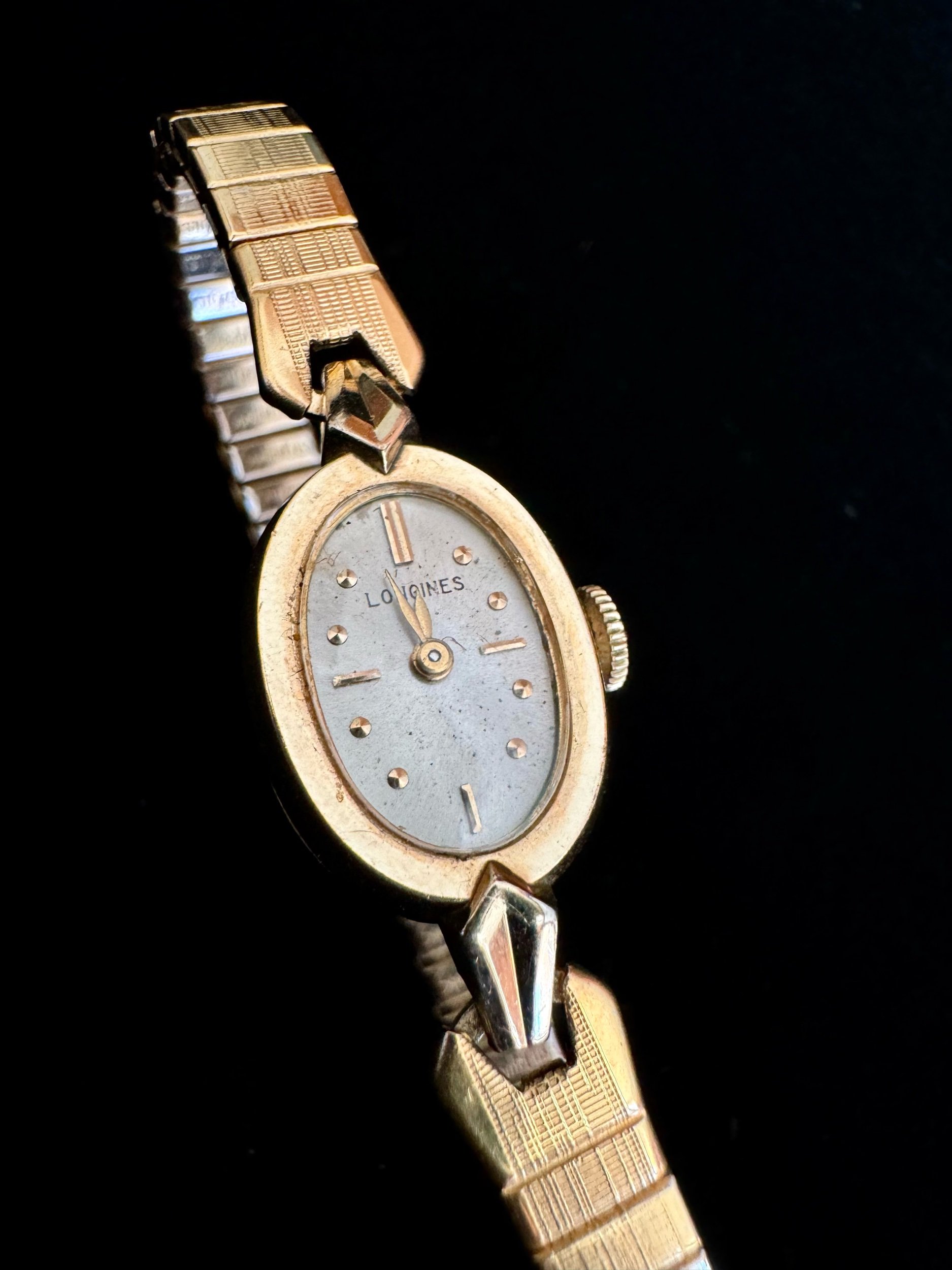 Vintage gold Longines mechanical watch with classic design, keeps time for 14 hours on a single wind