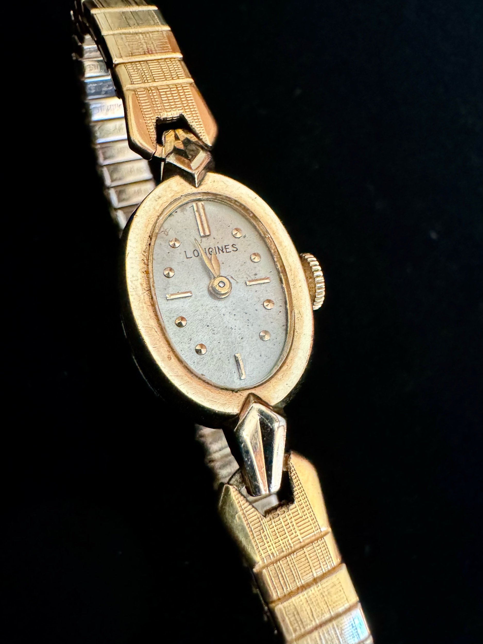 Close-up of vintage Longines watch face, showcasing elegant gold finish and fine craftsmanship