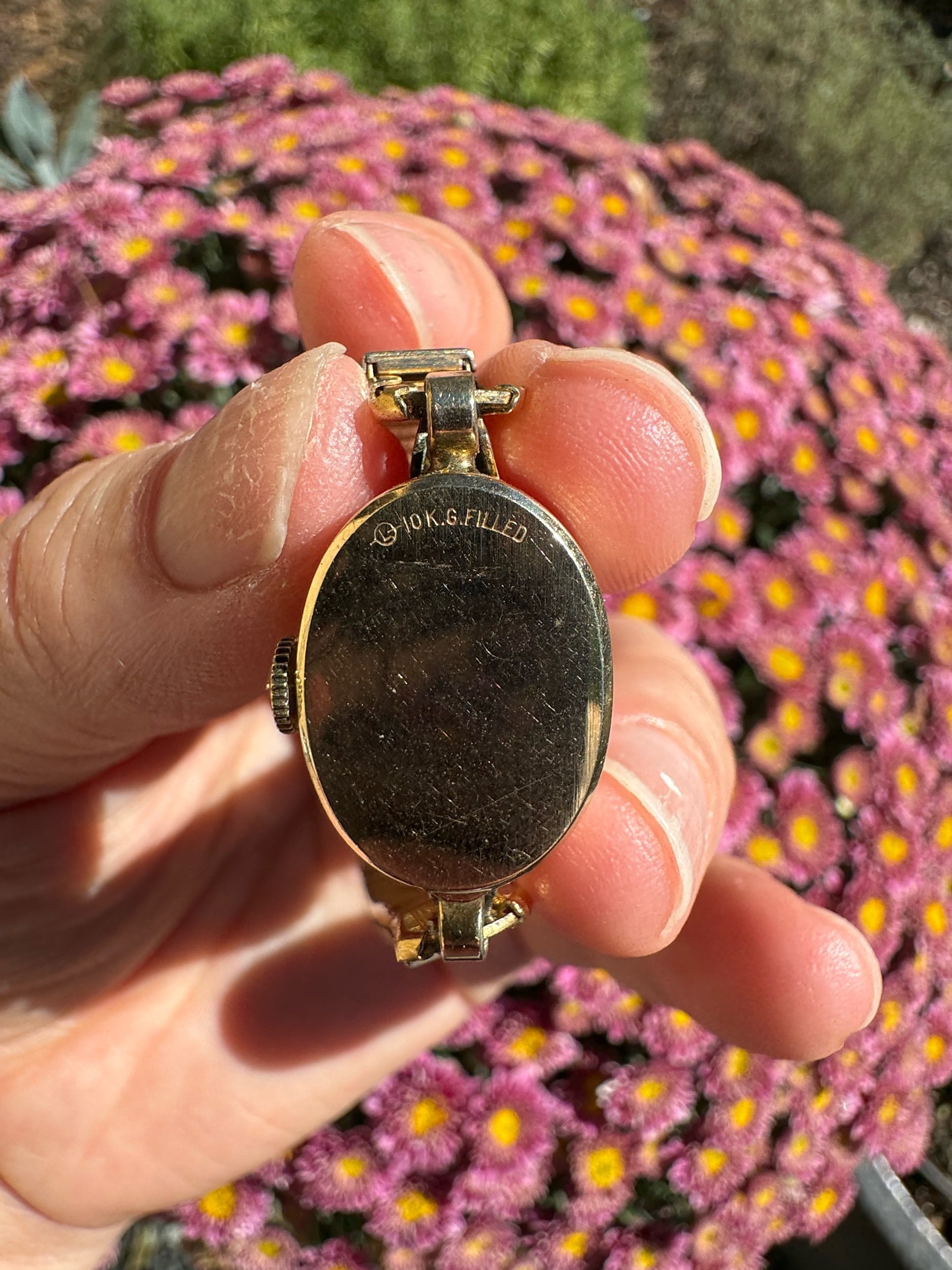 Back of vintage Longines gold watch case, a durable mechanical timepiece for collectors