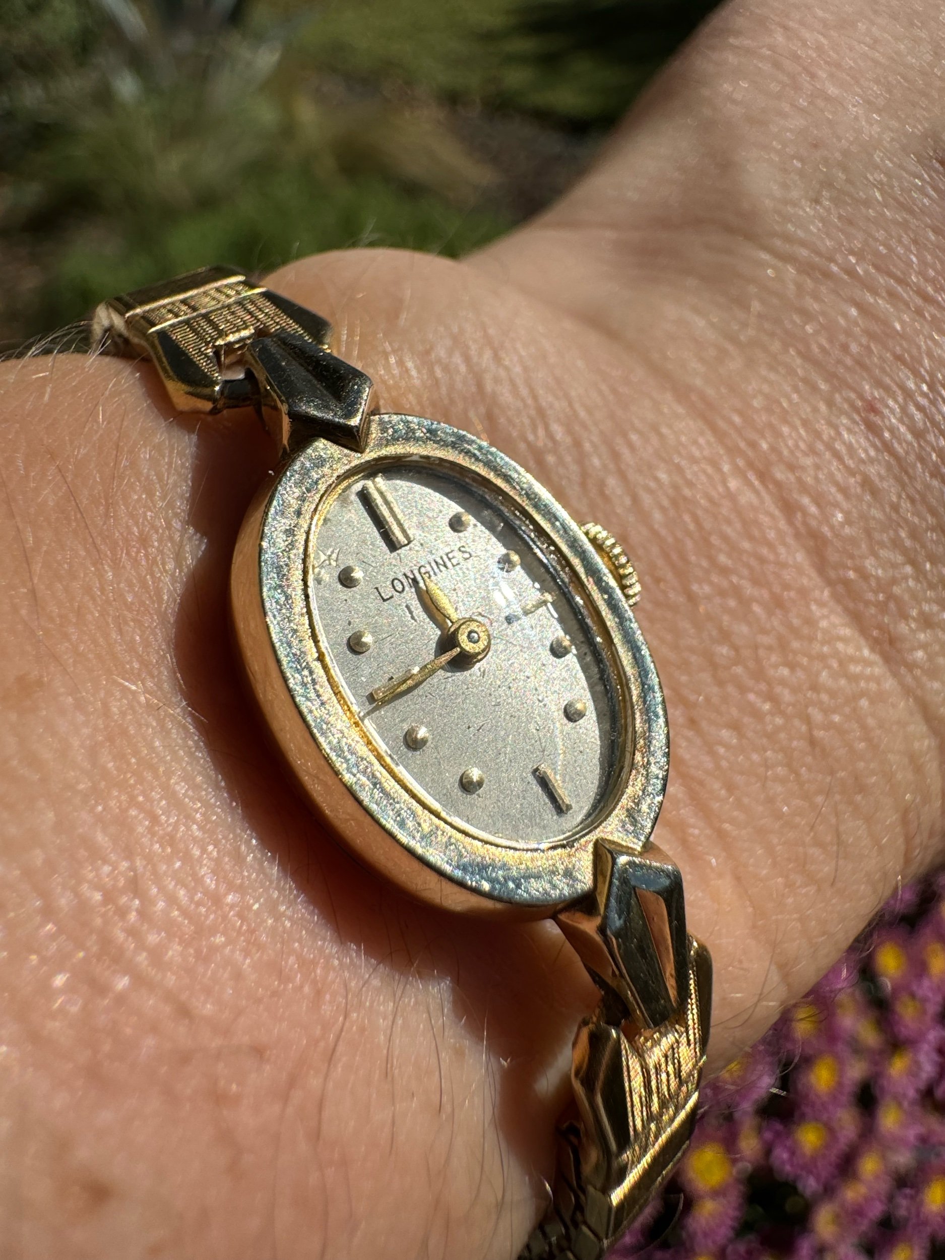 Close-up of vintage Longines watch face, showcasing elegant gold finish and fine craftsmanship