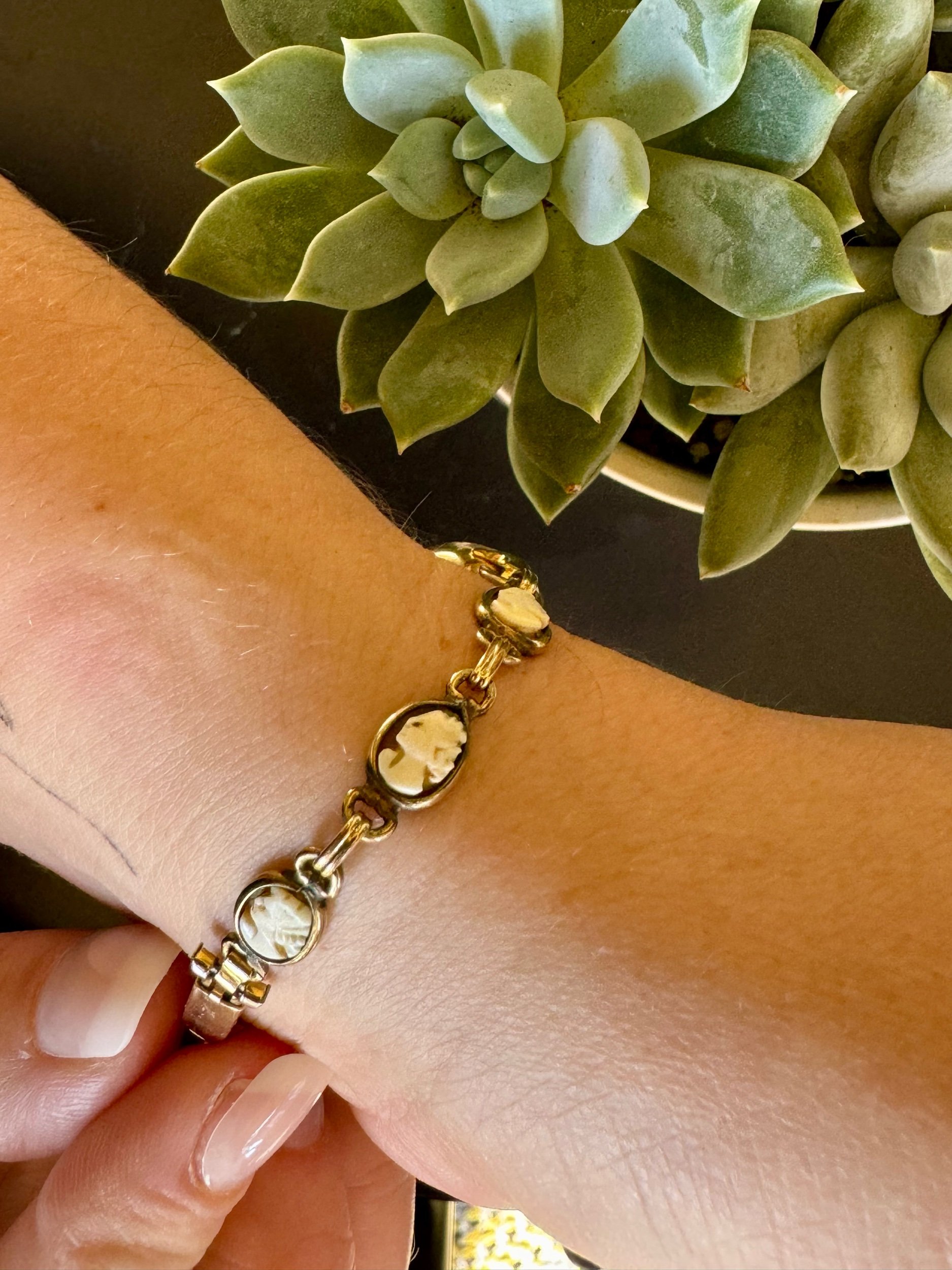 Side view of Waltman gold watch and cameo band, highlighting classic mechanical design and artistic band details