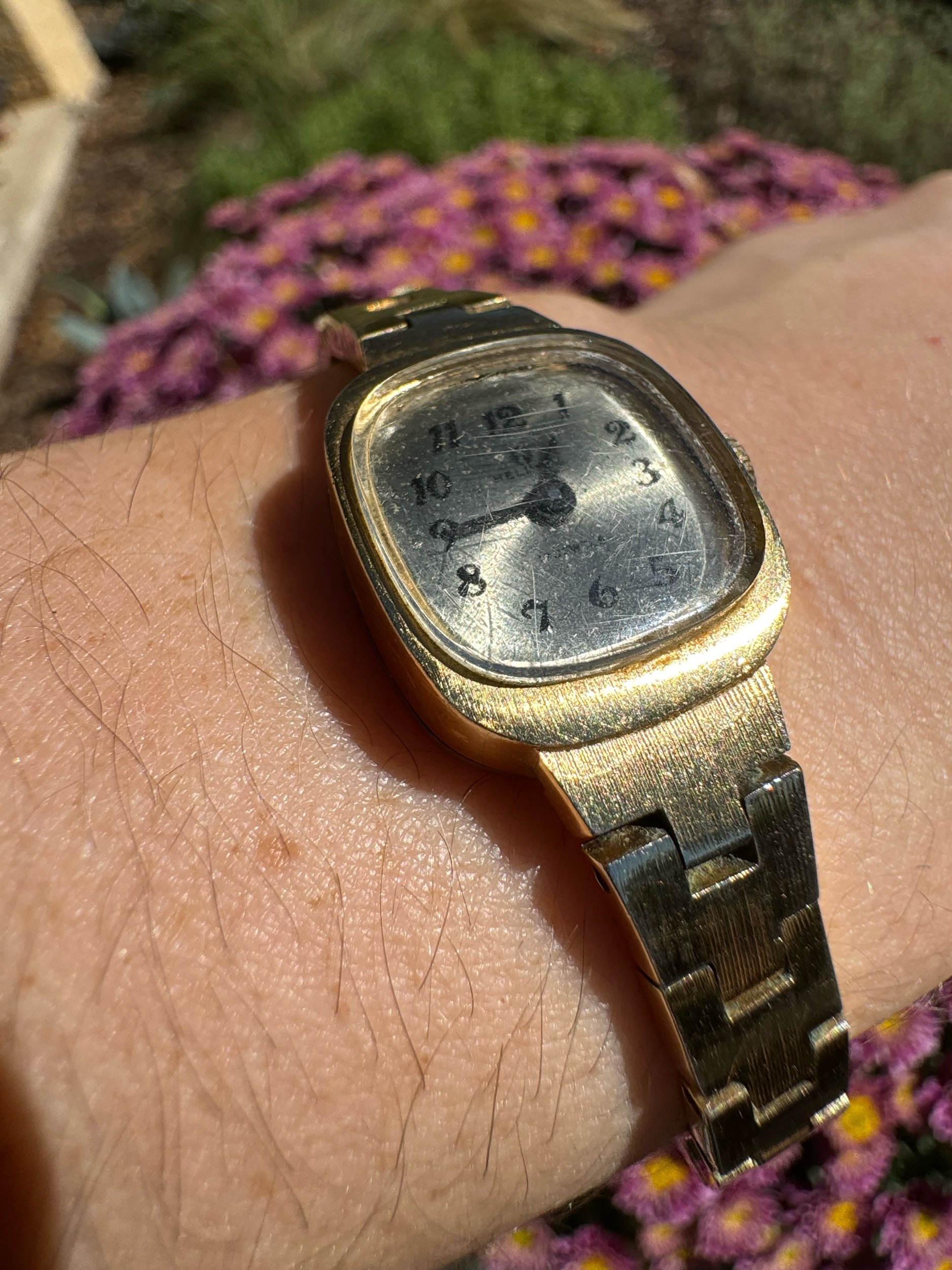 Close-up of the gold Helbros watch face, showcasing its timeless elegance and detailed craftsmanship
