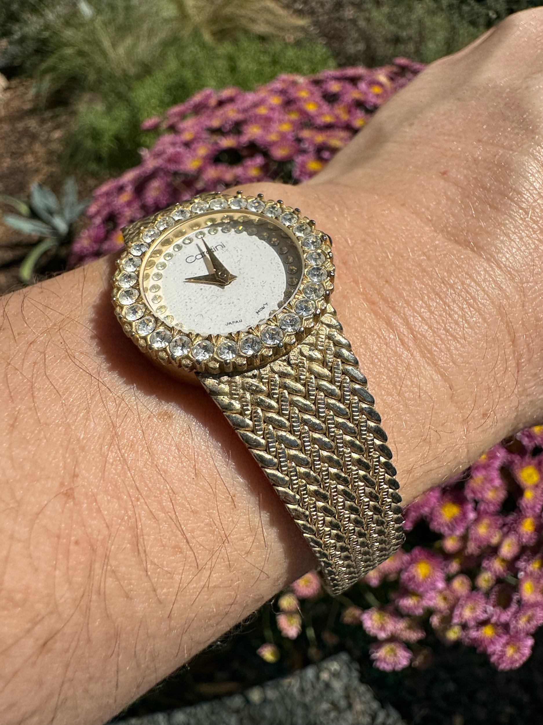 Close-up of vintage Cardini watch face, showcasing intricate details and classic gold finish.