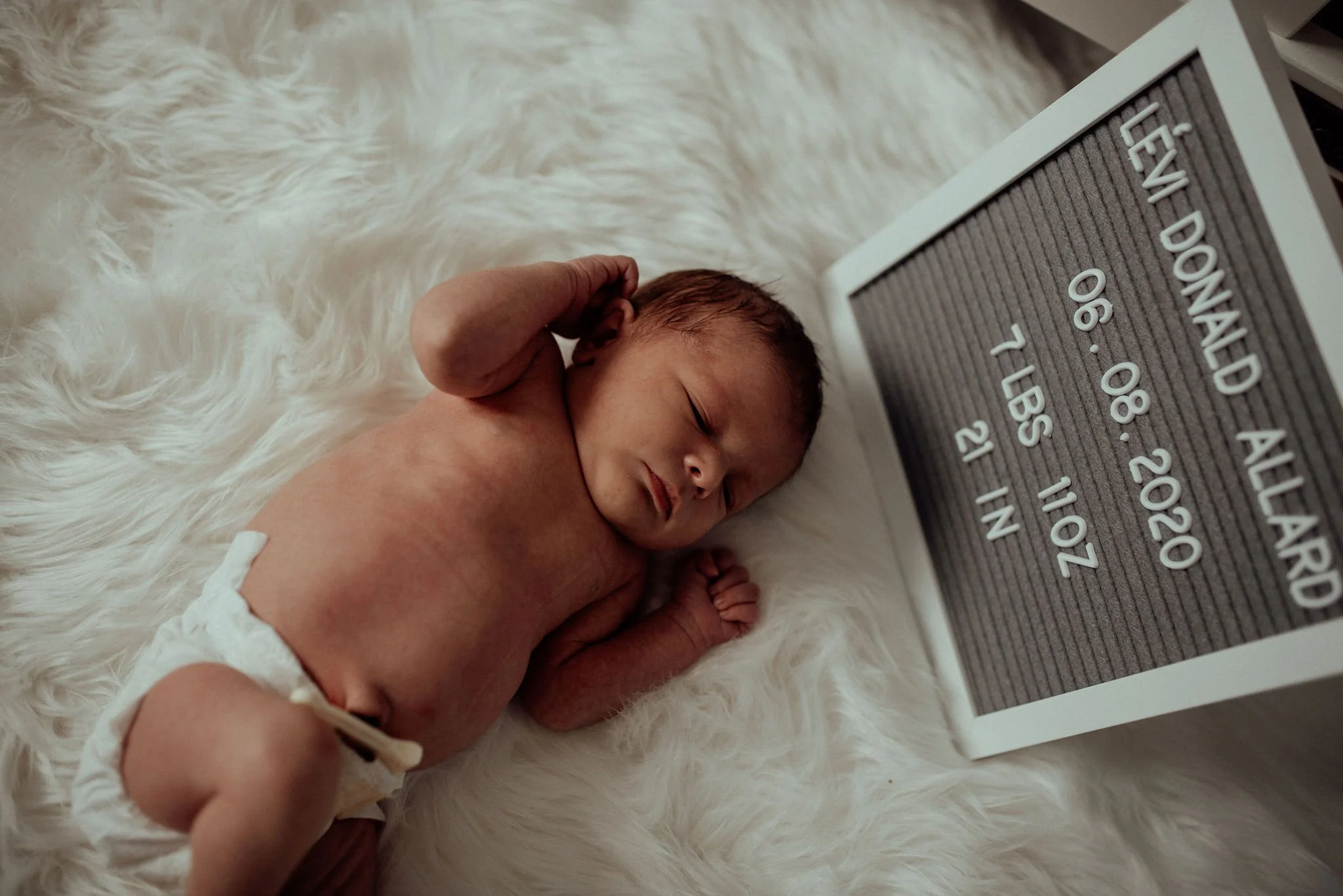 Postpartum doula supporting mother and newborn at home in San Bernardino County.