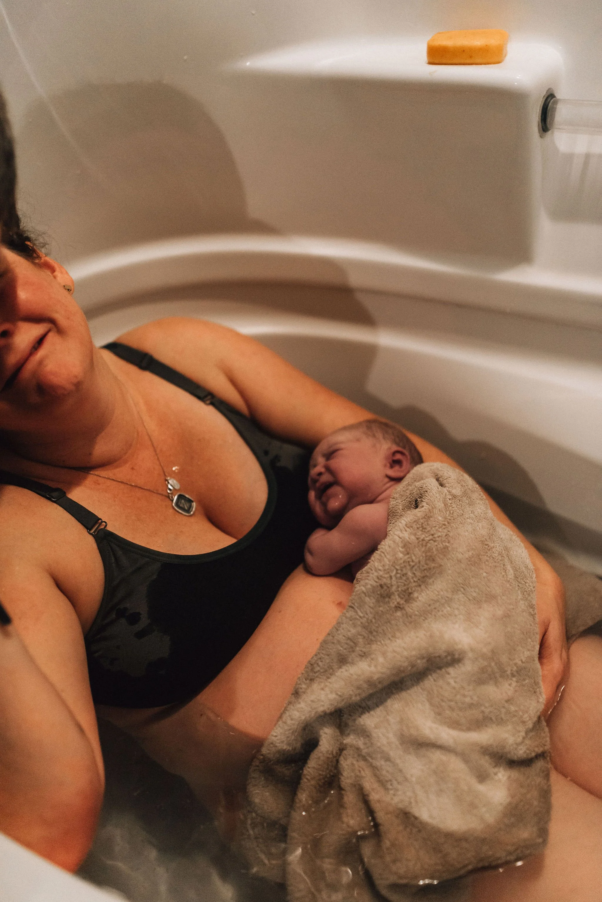 Birth doula providing continuous labor support in San Bernardino County hospital.