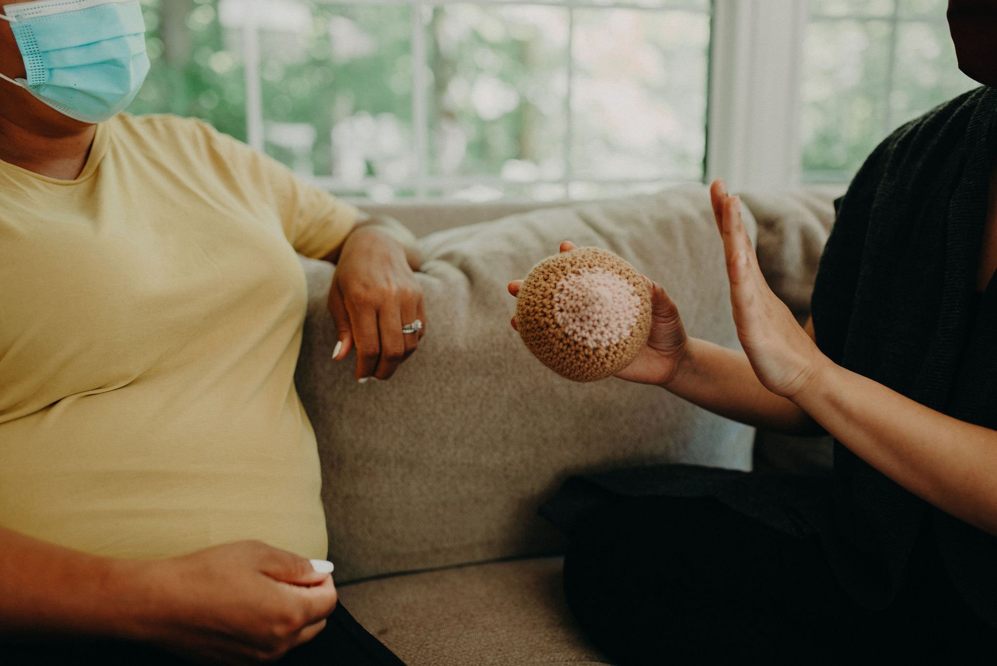 Doula trainee practicing counterpressure techniques to support a laboring mother during hands-on doula training