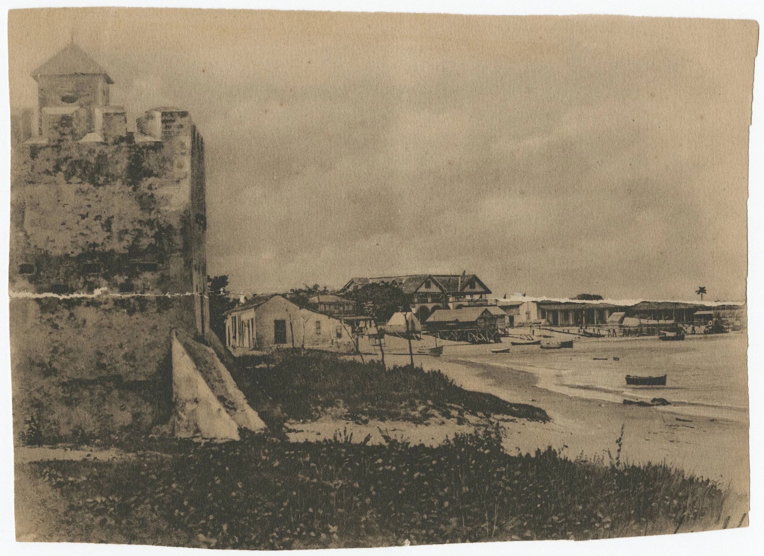 A sepia-toned photograph of a coastal scene with docks and boats, and a building resembling a lighthouse or tower on the left.