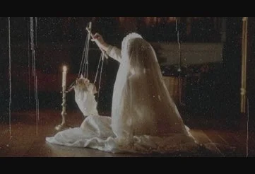 Anne playing with a marionette in her Communion gown in The Others - or is it?