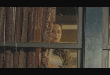 Ms. Valerie Lewton peering anxiously out of her window in Final Destination