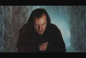 Jack chases Danny through the snow covered hedge maze