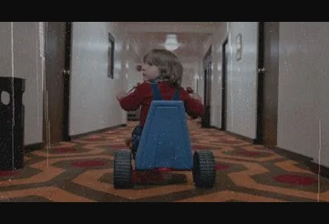 Danny riding his trike through the Overlook hotel