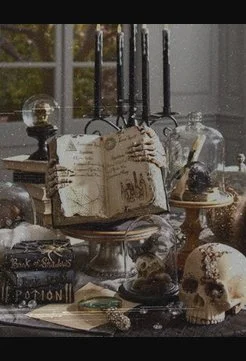 halloween centrepiece with old book, skull, potions