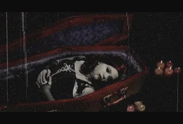 woman sleeping in a coffin