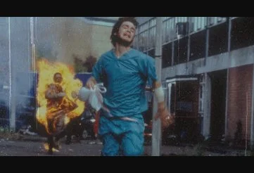 Jim is chased by a burning infected man in 28 Days Later