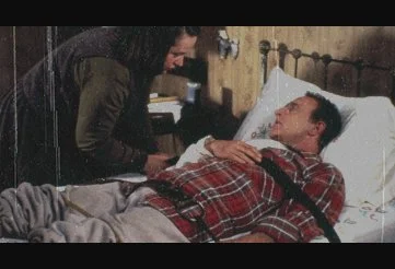 Annie Wilkes holding Paul Sheldon captive in Misery
