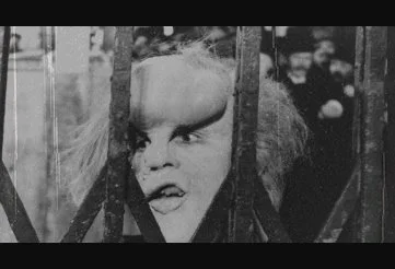John Merrick trapped by a panicked mob pursuing him like a hunted animal in The Elephant Man