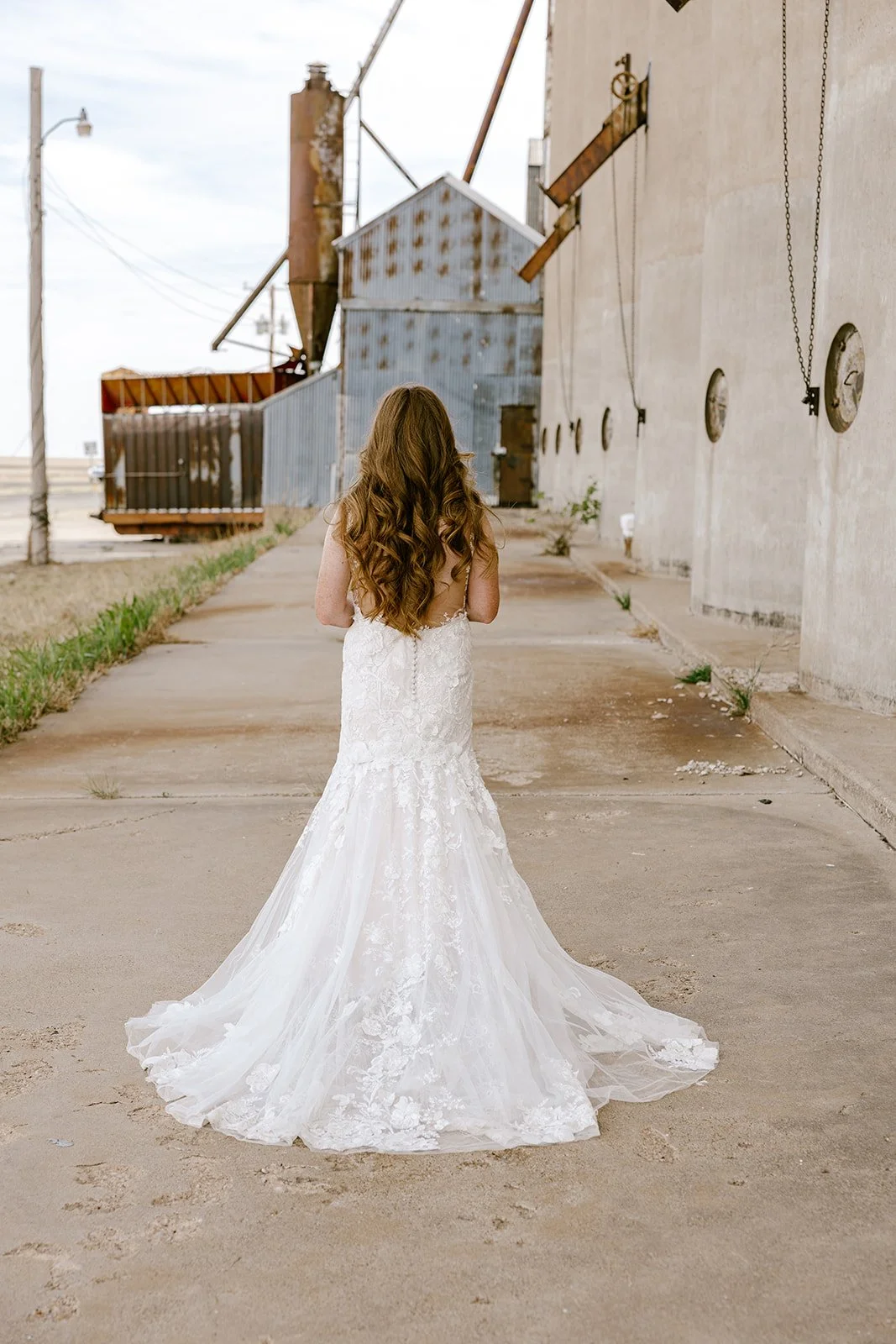 towering concrete grain silos creating a unique backdrop for wedding photography