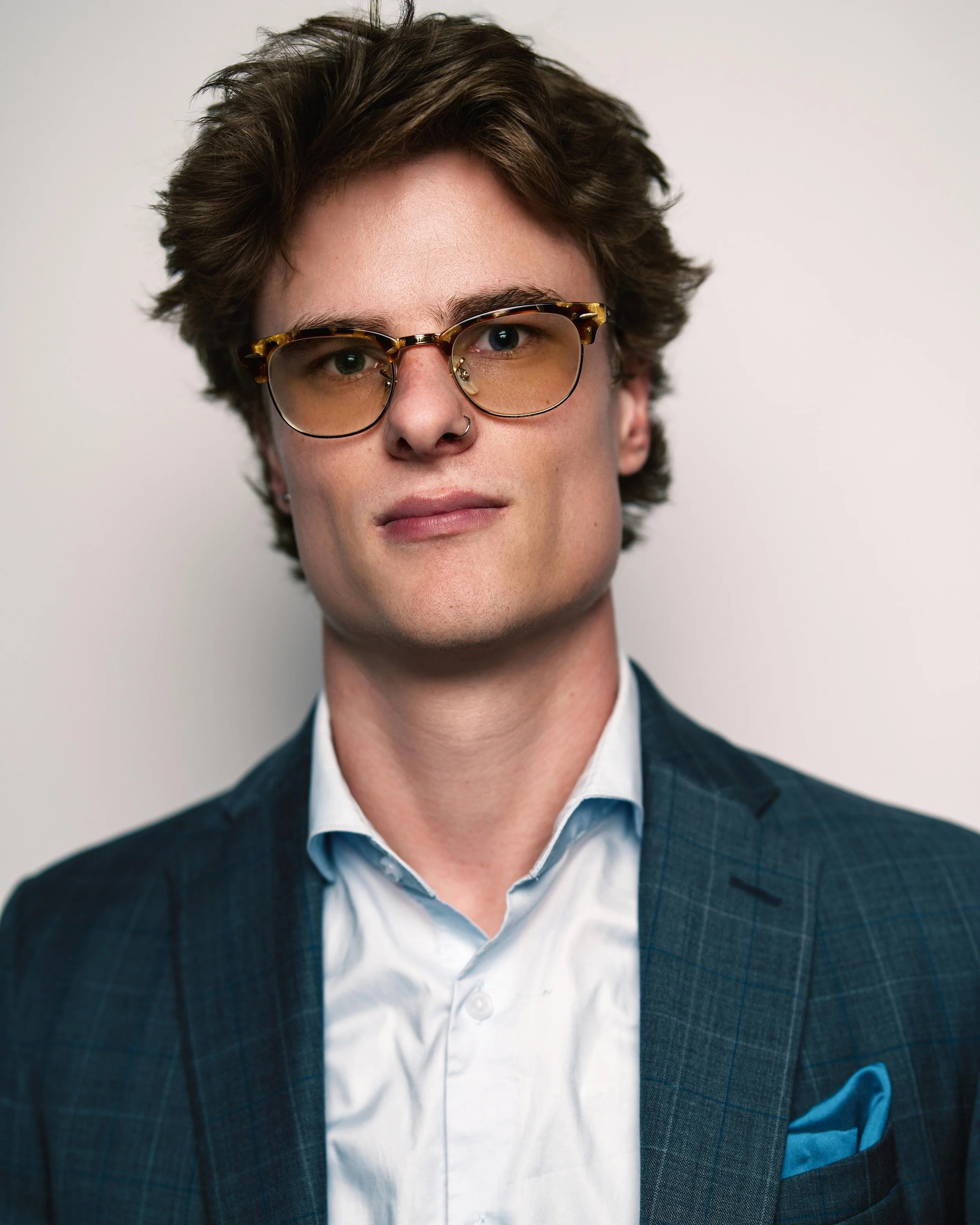 Headshot of man in suit with sunglasses